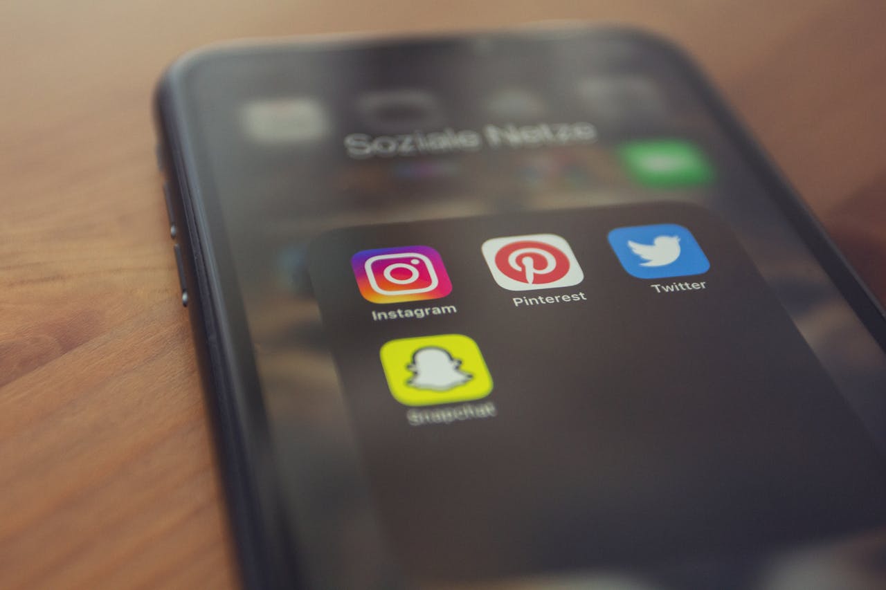 heros-img Smartphone displaying popular social media apps like Instagram, Pinterest, Twitter, and Snapchat.